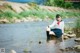 A woman in a school uniform is sitting in the water.