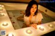 A woman sitting in a bathtub surrounded by candles.